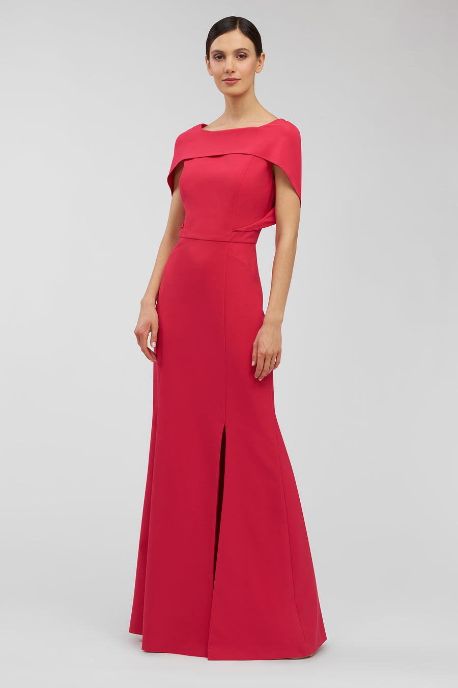 Woman wearing a red evening gown on a light gray background