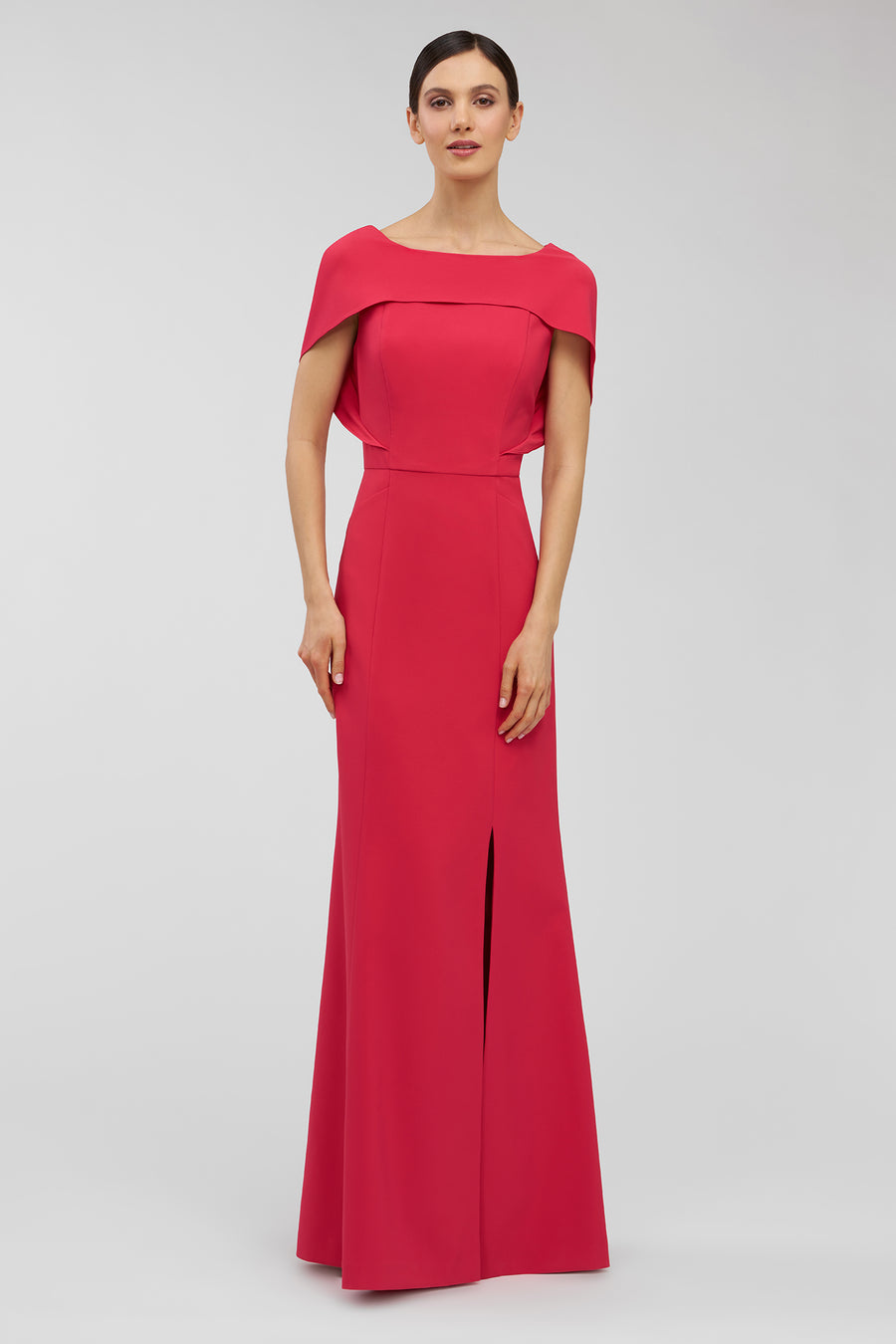 Woman wearing a red evening gown on a light gray background