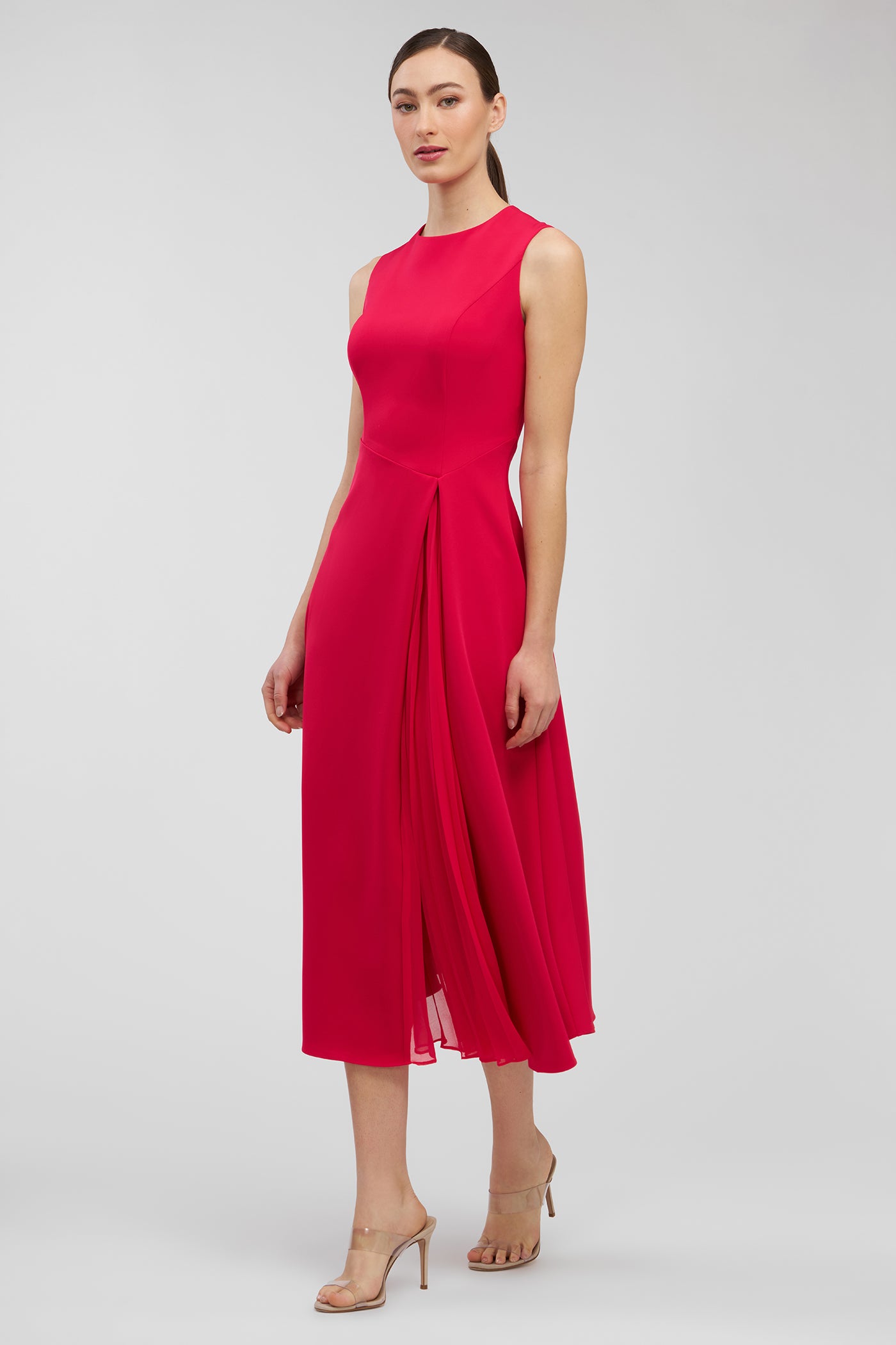 Red dress worn by a model on a white background