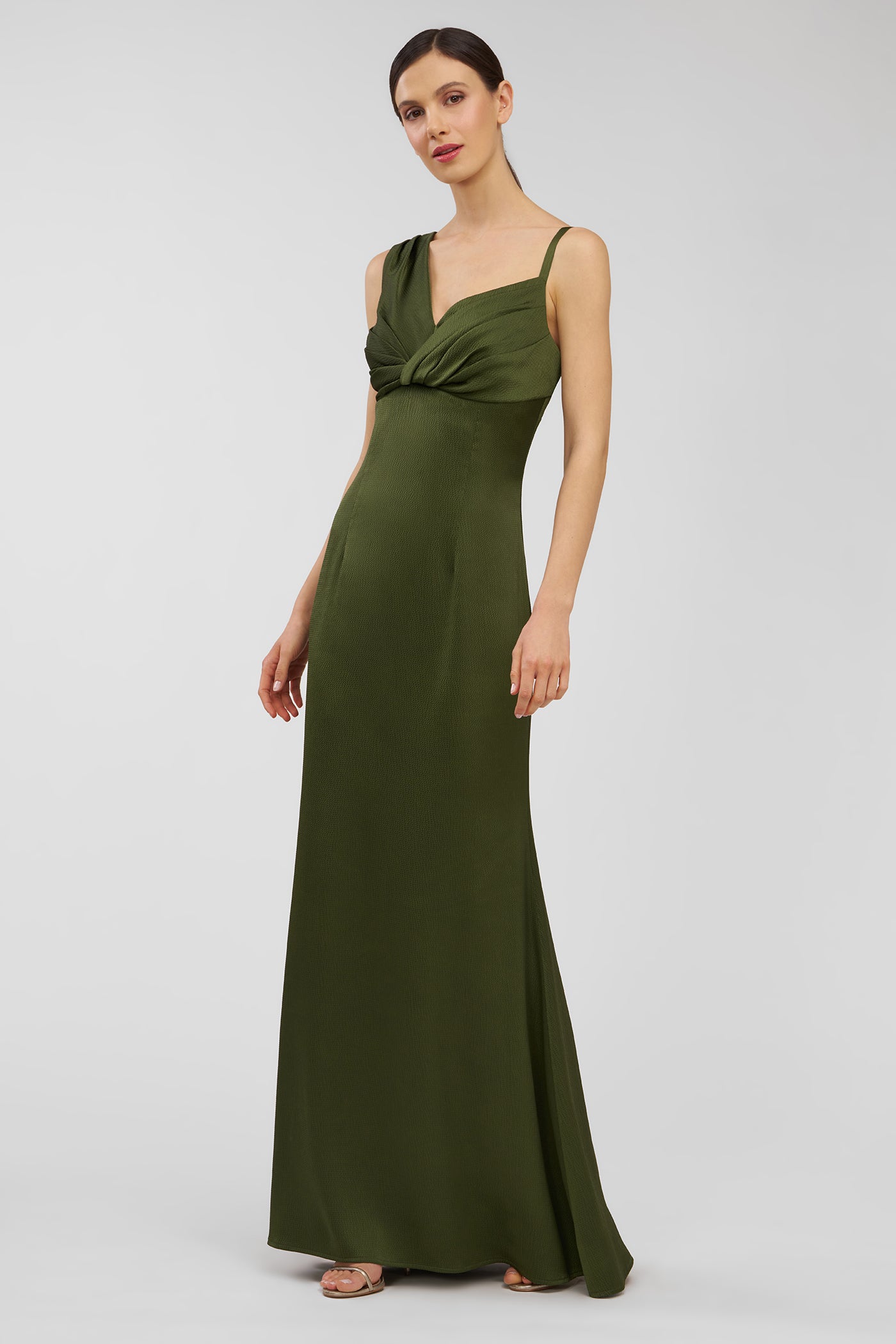 Woman wearing a green evening gown on a white background