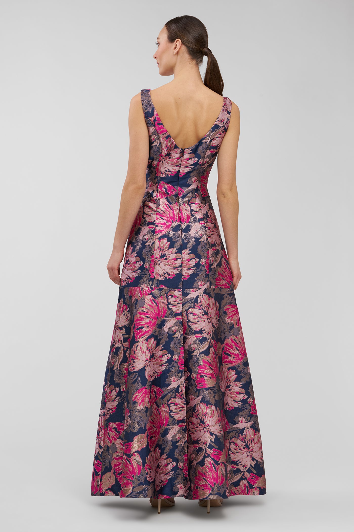 Woman wearing a floral dress with a plain background