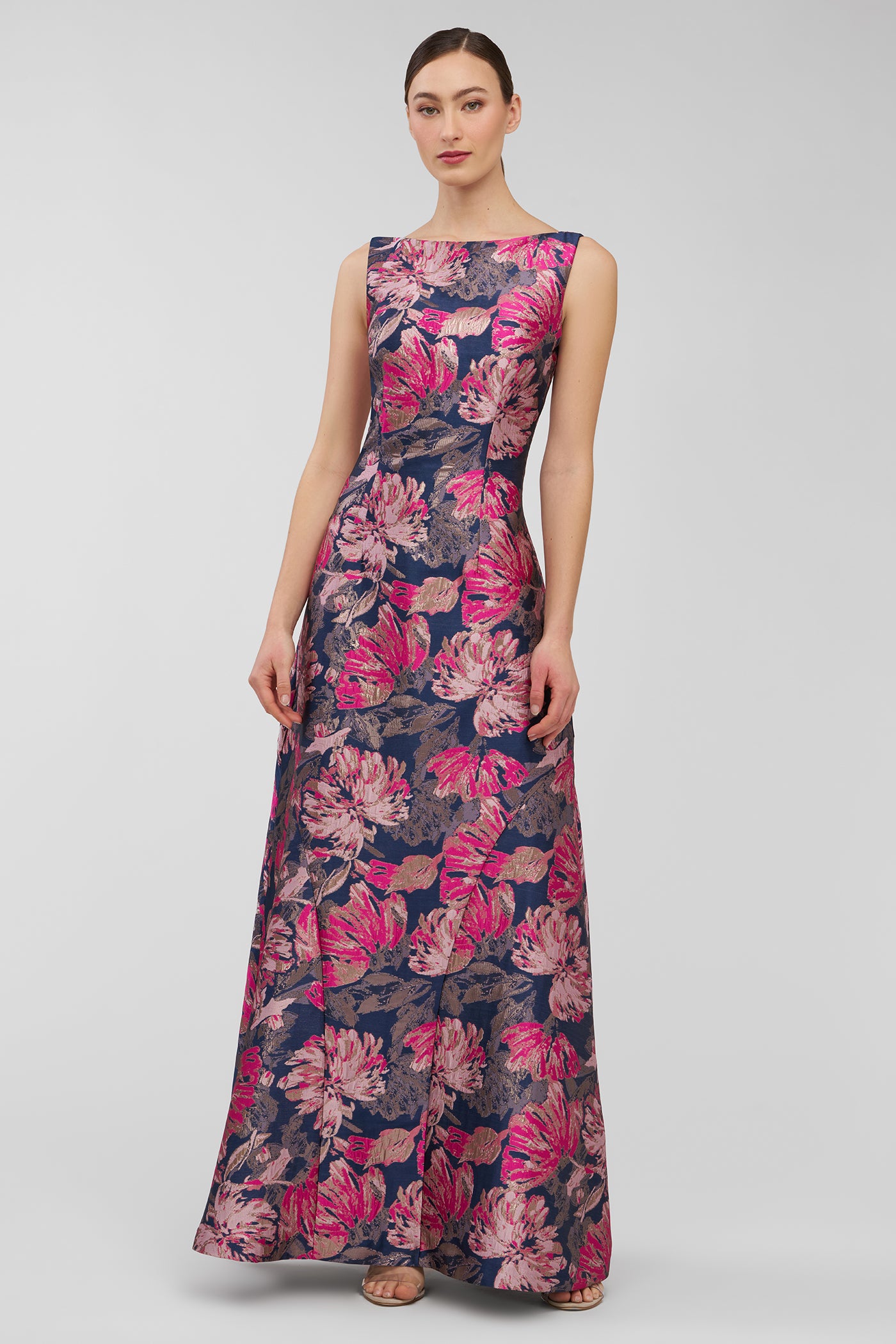 Woman wearing a floral patterned dress on a plain background