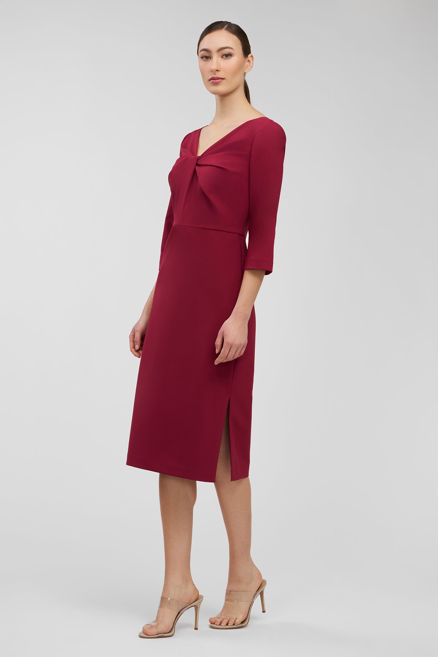 Woman wearing a burgundy dress with a plain background