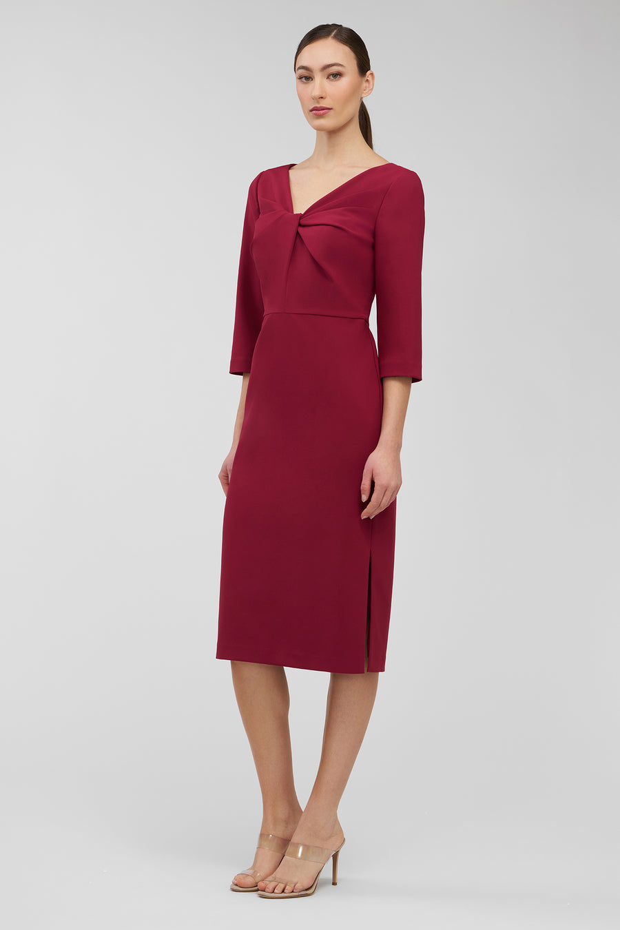 Woman wearing a burgundy dress with a plain background