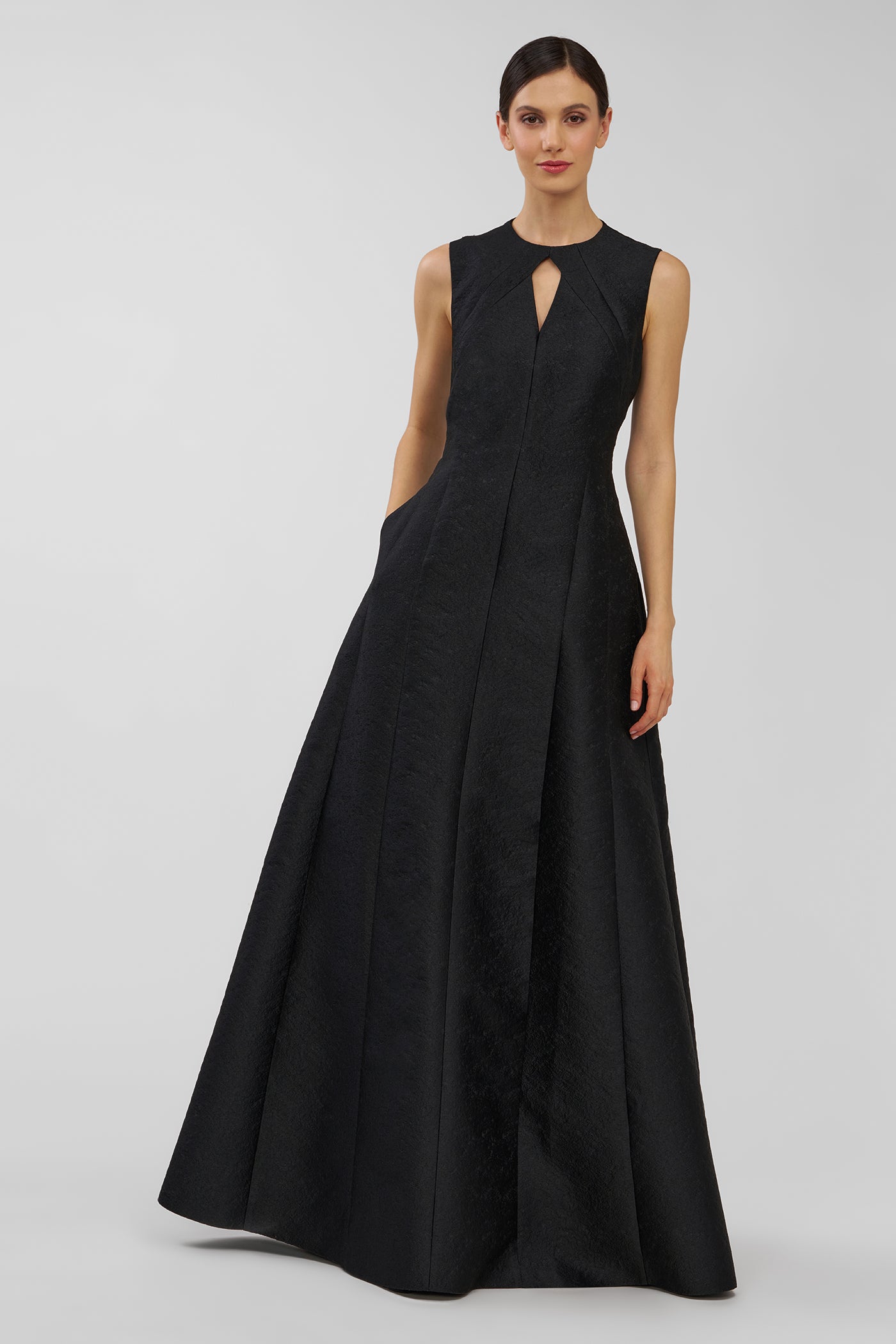 Black evening gown on a model against a plain background