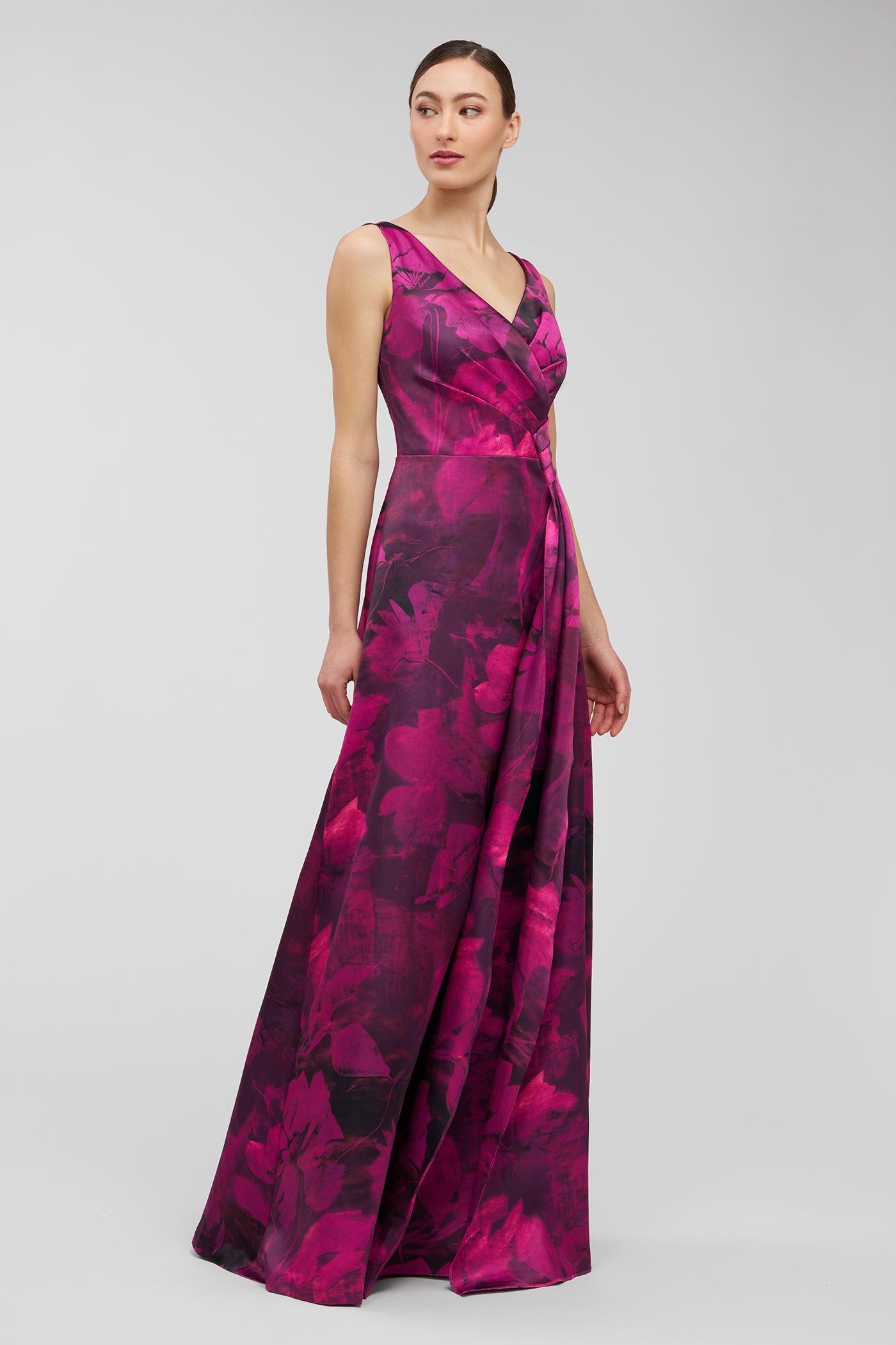 Woman wearing a pink floral dress on a gray background